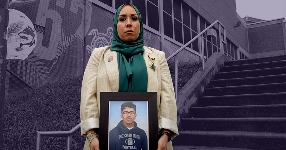 Meredith Elizalde holding a photo of her son Nick in front of the mural created in his honor